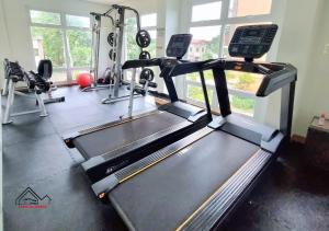 a gym with a treadmill and a tread machine at Affordable and Elegant 2BR Apartment with a Balcony plus FREE Swimming Pool and Gym-5Kunzite in Puerto Princesa City
