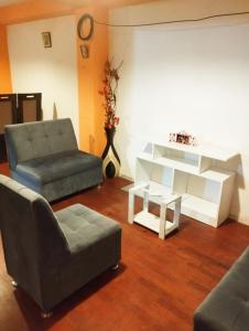 a living room with a couch and a coffee table at Cruz Apartments - Centro Histórico de Cusco in Cusco