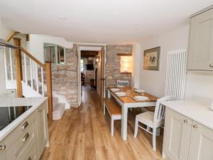 a kitchen and dining room with a table and chairs at Tannery Cottage in Much Wenlock