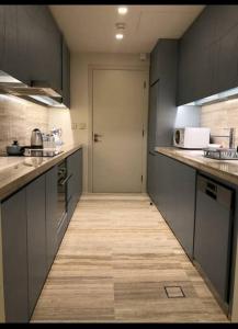 a large kitchen with a door in the middle of it at Luxury Towers Apartment in Downtown in Riyadh