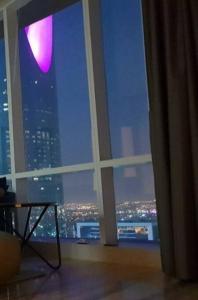 a room with a window with a view of a city at Luxury Towers Apartment in Downtown in Riyadh