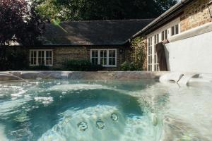 a swimming pool with an elephant in the water at Greenwood Grange in Dorchester