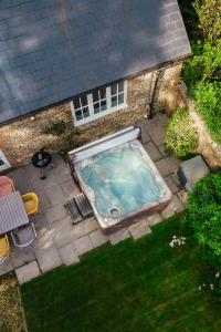 an overhead view of a swimming pool in front of a house at Greenwood Grange in Dorchester