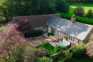 an aerial view of a house with a swimming pool at Greenwood Grange in Dorchester