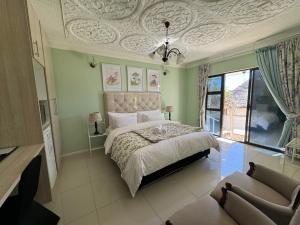 a bedroom with a bed with a coffered ceiling at Blue Diamond Lodge in Springbok +55 photos