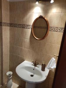 a bathroom with a sink and a mirror at TERRA LUXURY HOME in Drama