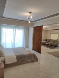 a bedroom with a bed and a living room at TERRA LUXURY HOME in Drama