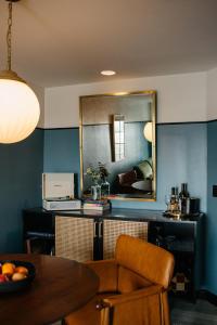 a living room with a table and a mirror at Hotel Emeline in Charleston
