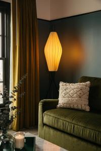 a living room with a couch and a lamp at Hotel Emeline in Charleston