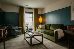 a living room with a couch and a table at Hotel Emeline in Charleston