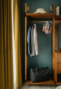 a closet with a black bag on a shelf at Hotel Emeline in Charleston