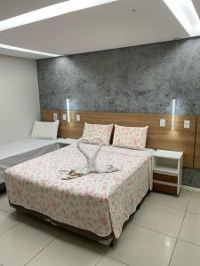 Giường trong phòng chung tại Pousada Beija Flor