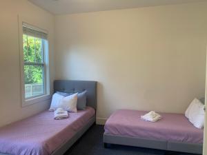 two beds sitting next to each other in a room at The Popular Pad in Downtown Raleigh, NC in Raleigh