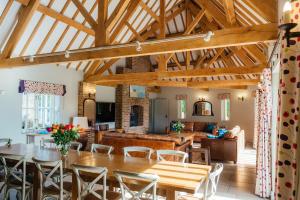 a kitchen and living room with a wooden ceiling at Greenwood Grange in Dorchester