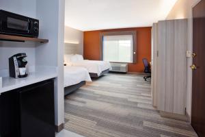 um quarto de hotel com duas camas e uma televisão em Holiday Inn Express Hotel & Suites Rochester Webster, an IHG Hotel em Webster