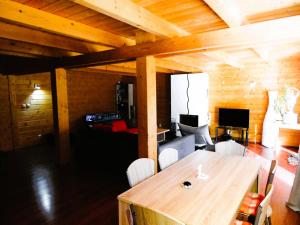 Habitación de madera con mesa y sala de estar. en Zrub Alpinus, en Pribylina