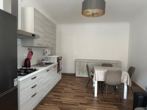 a kitchen with a table and a table and chairs at Appartamento centro storico Pordenone in Pordenone