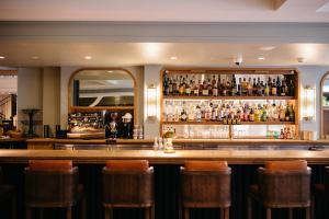 a bar with a lot of bottles of alcohol at Hotel Emeline in Charleston