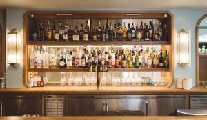 a bar filled with lots of bottles and glasses at Hotel Emeline in Charleston