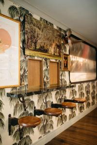 a wall with a bunch of stools in a room at Hotel Emeline in Charleston