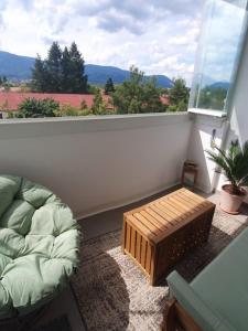 a balcony with a dog bed and a window at Apartmán Pohoda in Martin