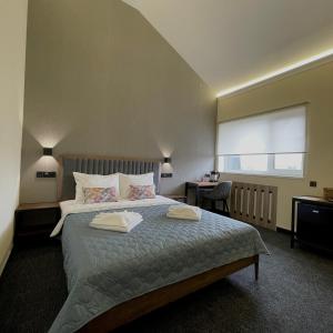 Ένα ή περισσότερα κρεβάτια σε δωμάτιο στο Hotel Nivki