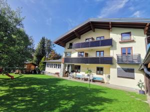 a large house with a lawn in front of it at Oberauer Wagrain - Die Eco Familien Hotelpension B&B in Wagrain