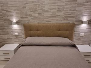 Giường trong phòng chung tại I Gerani appartamento bilocale deluxe
