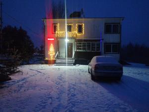 a house with a car parked in front of it in the snow at Sangis Haparandavägen 11 in Sangis