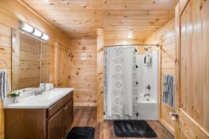 a bathroom with a white sink and a shower at Brand New Luxury Cabin-Private Appalachian Retreat in Gatlinburg +26 photos