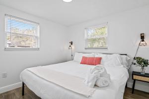 Un dormitorio con una cama blanca con toallas. en The Peaceful Village Unit #1, en Plant City