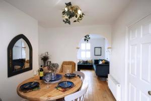 a dining room with a table and a living room at Ivy Cottage in Henley on Thames