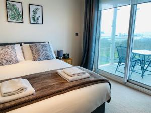 Un dormitorio con una cama grande y un balcón. en Seascape Apartment, en Portland