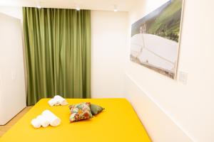 a room with a yellow table with towels on it at FLORIANA B&B in Nuova Gibellina