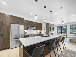 a kitchen with a large kitchen island with bar stools at 541 Center Circle 3Br 3,5Ba townhouse in Silverthorne