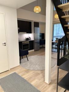 a living room with a kitchen and a dining room at Bright loft apartment with glazed balcony in Tampere