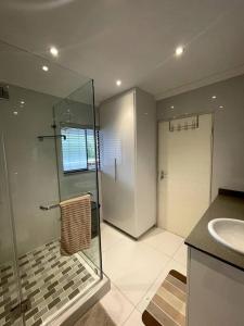 a bathroom with a glass shower and a sink at Unit 604 Shoreline in Freeland Park