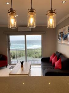 a living room with a couch and a view of the ocean at Unit 604 Shoreline in Freeland Park