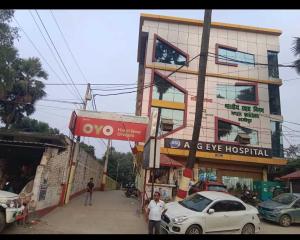 a building on a street with cars parked in front of it at OYO Flagship Hotel New Urvashi in Hājīpur