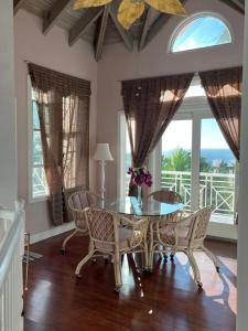 a dining room with a glass table and chairs at Royal Palm Villas 