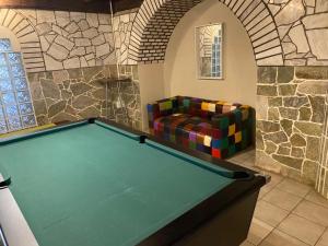 a pool table in a room with a couch at Kappsfarm Guesthouse in Voigtland