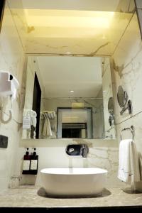 a bathroom with a sink and a large mirror at BluSalzz Residence Amritsar in Amritsar