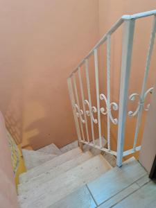 a flight of stairs with a metal railing at B&B Monolocale Piazza Dante in Teramo