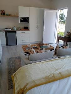 a living room with several couches and a kitchen at 19, Ridge House in St Francis Bay