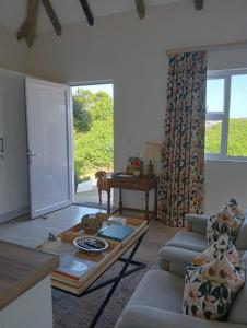 a living room with a couch and a table at 19, Ridge House in St Francis Bay