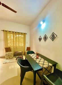a room with a table and chairs and a couch at Mitra Homes - Mandrem in Mandrem