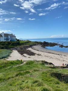 a beach with a house and the ocean at Montrose 25 in Turnberry