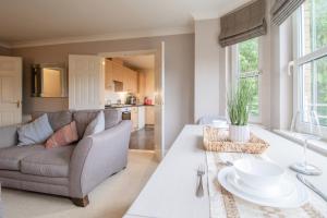 una sala de estar con un sofá y una mesa en Garden View Nook-2 bed apartment, en High Blantyre 34 fotos más