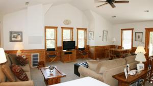 a living room with a couch and a tv at Oceanside, SUN-SUN, Keyless Entry, Community Pool, SA39, Sibert- Alls Well in Sanderling