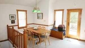 a dining room with a wooden table and chairs at Oceanside, SUN-SUN, Keyless Entry, Community Pool, SA39, Sibert- Alls Well in Sanderling